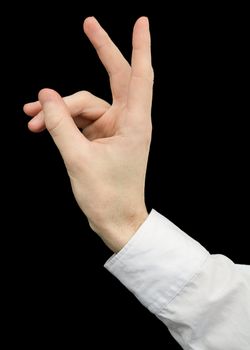 Hand emitting a rabbit on black background