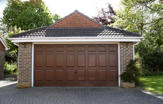 A detached garage on a driveway