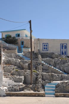 beautiful greek scene with blue and white stairs and house (Pserimos island)