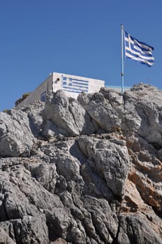 gorgeous greek house and flag on the stones of Pserimos island