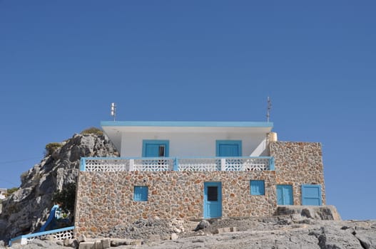 beautiful greek scene with blue and white stairs and house (Pserimos island)