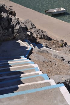 traditional white and blue stairway in a Pserimos greek island (focus on the stairs)