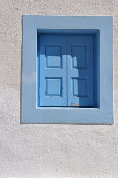 lovely blue window on white house in Greece