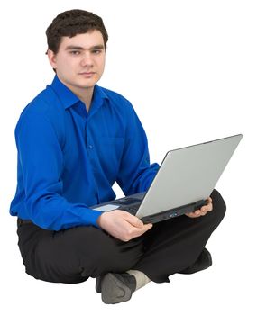 Businessman sits on a floor with the laptop in lap