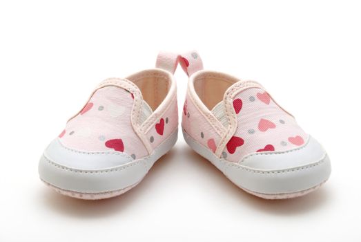 A pair of baby girls shoes on white background.