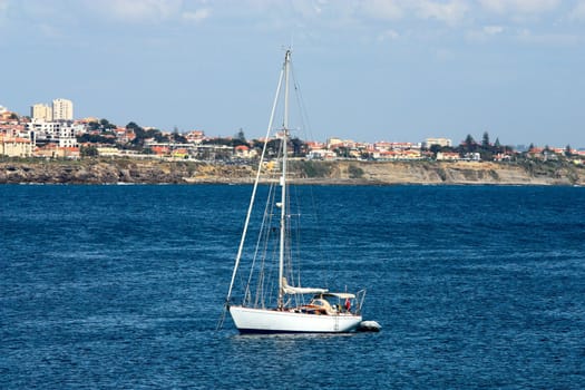 The large, beautiful yacht in the light-blue sea.