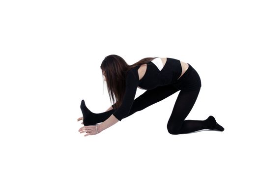 Young gymnast in black in studio with background