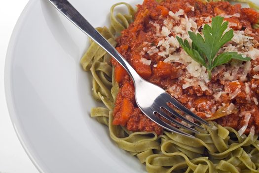 tagliatelle with sauce bolognaise in white plates