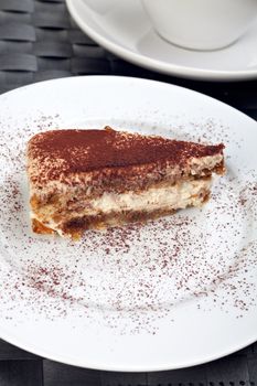 slice of a tiramisu cake on a white plate