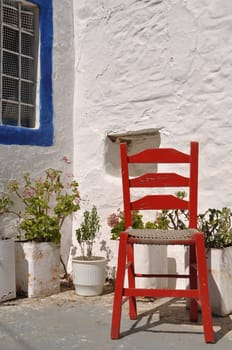 traditional greek house with red chair in Zia village (Kos), Greece