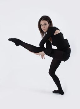 Young gymnast in black looking at the camera