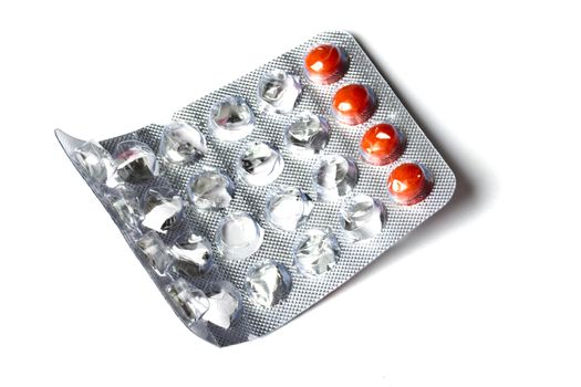 some red pills isolated on white background 
