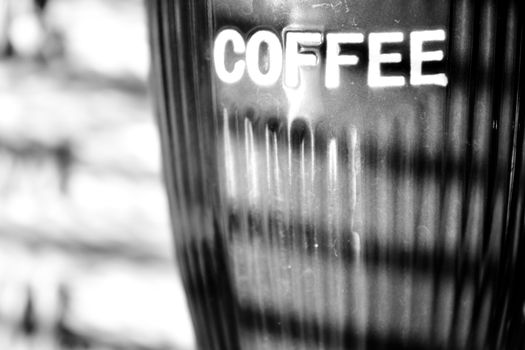 close up photo of coffee mug and window blinds reflection