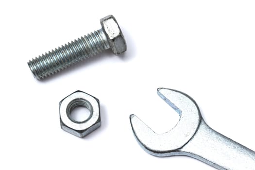 Wrench and bolt isolated on white background 

