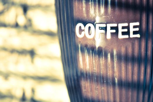 close up photo of coffee mug and window blinds reflection