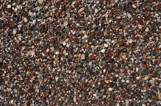 little and colorful stones at the beach (background or texture)