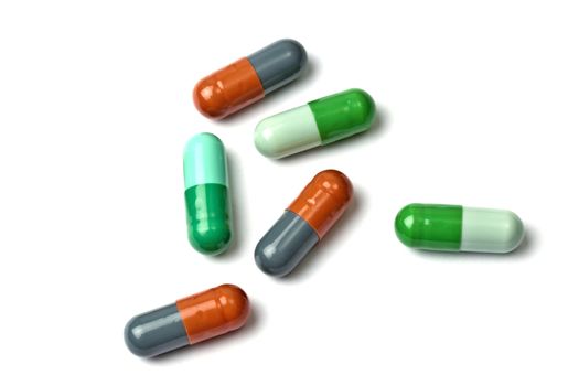 A few colorful capsules isolated on white background 
