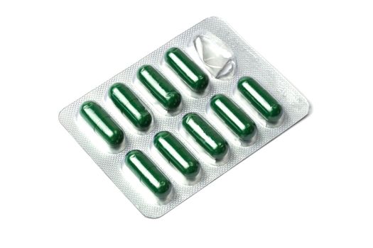 Green capsules packed in blister isolated on white 