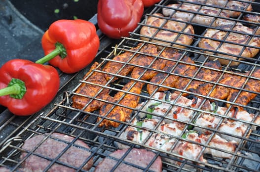 grilling fresh meat and peppers on a outdoor barbecue