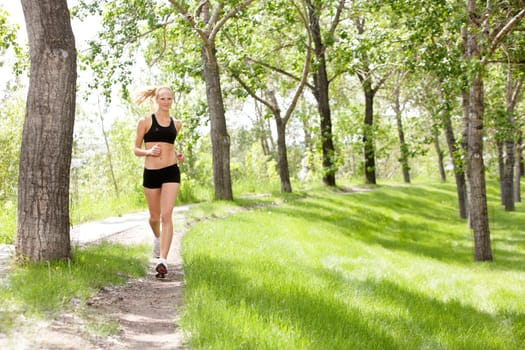 Portrait of a young beautiful smiling woman jogging