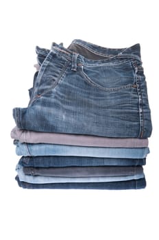 stack of various jeans isolated on white background