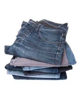 stack of various jeans isolated on white background