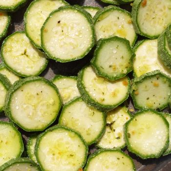 Green courgettes or zucchini vegetables useful as a background