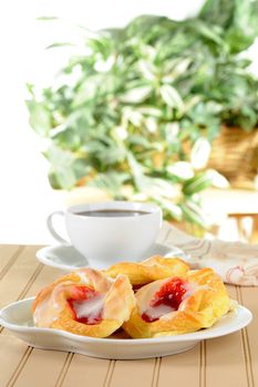 Fresh made cherry danish with black coffee.