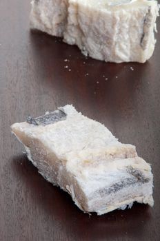 salted raw cod fish on a wooden background