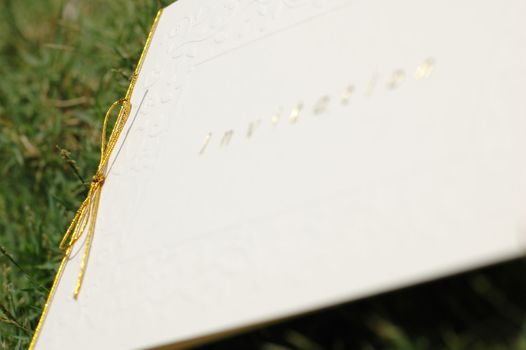 Invitation card with focus on the gold bow string