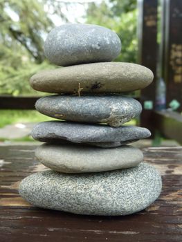 Zen stones on a peace of wood in a park