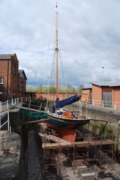 antique boat reparation at dry docks (cloudy weather)