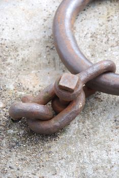 old and rusty mooring ring for ships on dock (shallow depth of field)