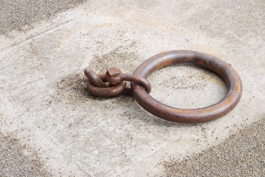 old and rusty mooring ring for ships on dock