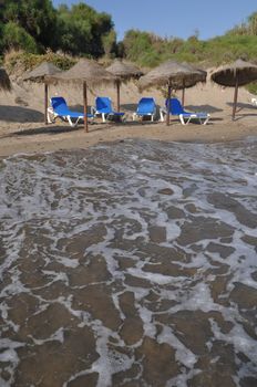 gorgeous beach view in Costa del Sol (Marbella) with umbrellas and chairs, Spain
