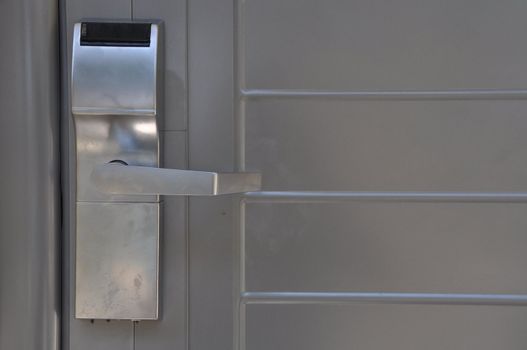 metallic hotel door handle which opens with a plastic card