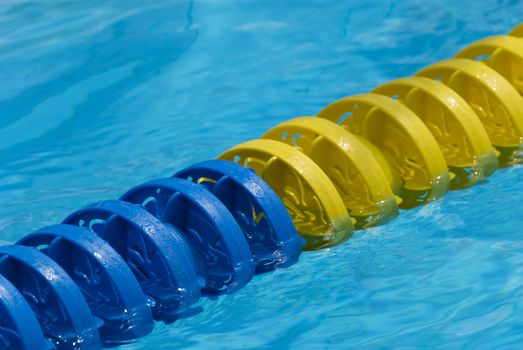 Swimming pool water surface detail with floaters.