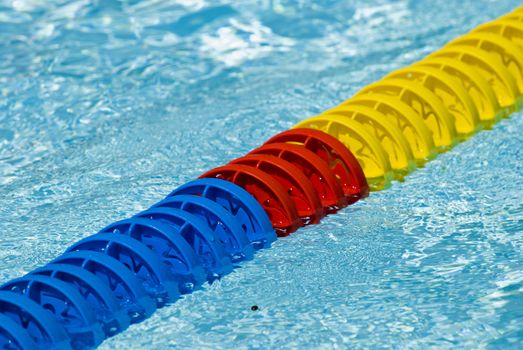 Swimming pool water surface detail with floaters.