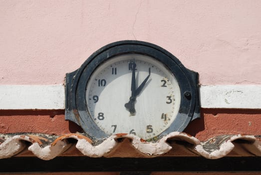 beautiful and retro clock on a pink building