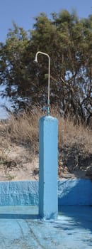 blue outdoor shower near the beach in Greece