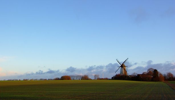 Morning light, traditional windmilland modern windmill generators