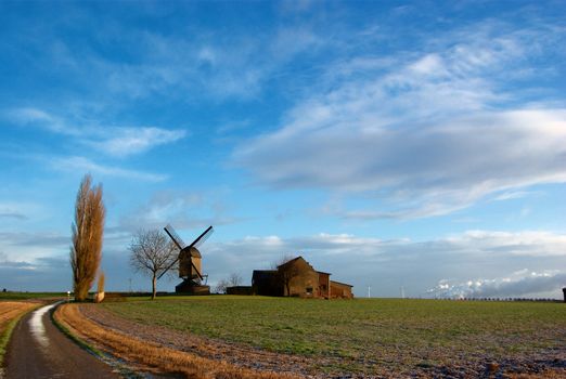 Morning light,field, traditional windmill and house, modern windmill generators on a background
