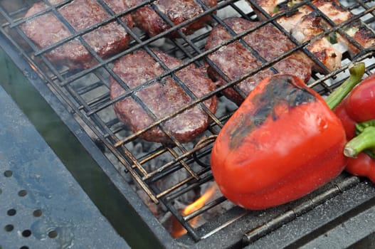 grilling fresh meat and pepers on a outdoor barbecue