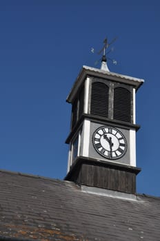 clock tower with weather vane on top of a building in Gloucester, England