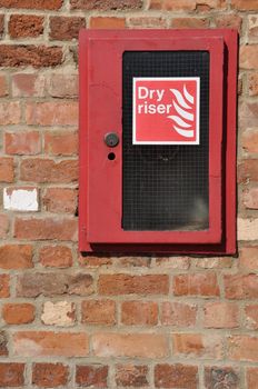 dry riser fire extinguisher inlet (brick wall background)