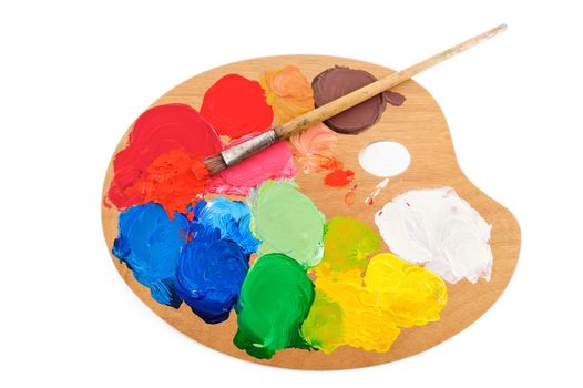 Paint brush on the palette with bright acrylic color