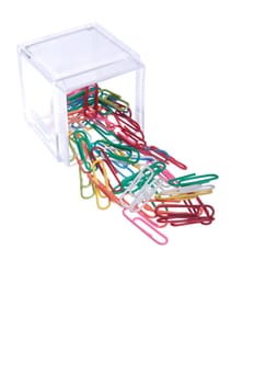 colored paper clips outside a plastic box isolated on white background