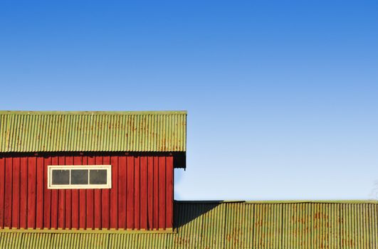 Barn on countryside with bright colors and blue sky background
