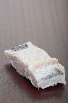 salted raw cod fish on a wooden background