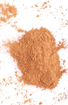cinnamon spice powder isolated on white background (chaotic version)